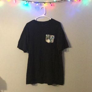 A Black tee shirt with a Hawaiian patterned pocket